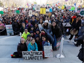 Swedish climate change teen activist Greta Thunberg takes a photo with local activists during a climate strike march at the Alberta Legislature in Edmonton, Alberta, Canada October 18, 2019.