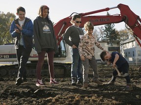 Sasha Fleming, left, Mackenzie Crane, Alexander Satterswaite, Max Moss and August Moss break ground on Wednesday, Oct. 16, 2019, at Urban Green Co-Housing, a 26-suite multi-generational, net-zero, non-combustible housing project located at 10115-88 Ave. in Edmonton. All five children will be living with their families at the housing project when it is completed.