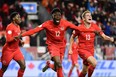 Team Canada’s Alphonso Davies (left) and Liam Fraser celebrate Davies’ goal against the Americans in the 63rd minute of Tuesday night’s CONCACAF Nations League match at BMO Field.