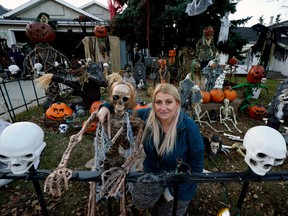 Kristy Gleason prepares for Halloween in the front yard of her south Edmonton home.