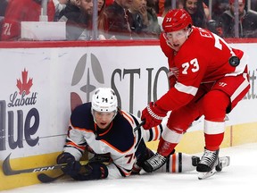 Edmonton Oilers defenceman Ethan Bear (74) and Detroit Red Wings left wing Adam Erne (73) battle for the puck in the second period at Little Caesars Arena on Tuesday, Oct. 29, 2019.