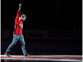 Washington Nationals pitcher Max Scherzer waves to the crowd after dropping the ceremonial first puck prior to the game between the Washington Capitals and the New York Rangers at Capital One Arena.