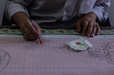 An artist hand draws a design that the rugmakers will use. The designs are influenced by thousands of years of tradition from various regions around Iran and the world.
