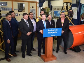 Standing with Chiefs, Premier Jason Kenney poses for photos after making an announcement toward a transformational commitment to reconciliation with Bill 14, at the Canadian Energy Museum near Devon, October 8, 2019.