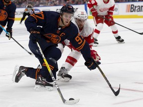 The Edmonton Oilers' Connor McDavid (97) battles the Detroit Red Wings' Patrik Nemeth (22) during second period NHL action at Rogers Place in Edmonton on Friday, Oct. 18, 2019.