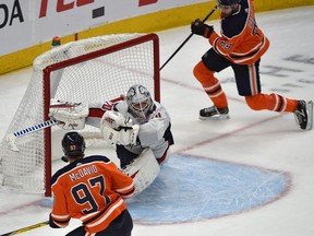 Edmonton Oilers Connor McDavid (97) passes to Leon Draisaitl (29) who scores in overtime on Washington Capitals goalie Braden Holtby (70) during NHL action at Rogers Place in Edmonton on Oct. 24, 2019.