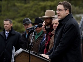 Surrounded by ranchers and agricultural industry representatives Environment and Parks Minister Jason Nixon announces the Public Lands Modernization Amendment Act outside the Alberta legislature in Edmonton on Tuesday, Oct. 15, 2019.