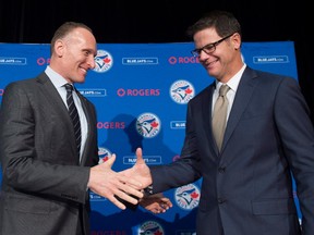 Toronto Blue Jays new general manager Ross Atkins, right, and Blue Jays president and CEO Mark Shapiro shake hands after answering questions during a press conference in Toronto on Friday, December 4, 2015.