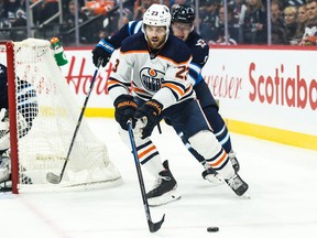 Edmonton Oilers forward Riley Sheahan skates away from Winnipeg Jets forward Andrew Copp during NHL action on Oct. 20, 2019, in Winnipeg.