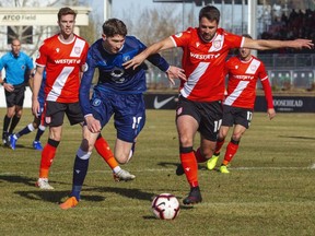 FC Edmonton striker Easton Ongaro challenges Jay Wheeldon of Cavalry FC at ATCO Field at Spruce Meadows in Calgary on Oct 19, 2019.