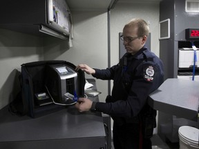 Const. Braydon Lawrence performs a drug test using an oral swab. The swab is used in the Draeger DrugTest 5000 to detect impairment by cannabis.