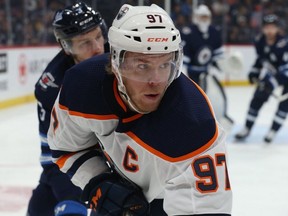 Edmonton Oilers centre Connor McDavid (right) is pursued by Winnipeg Jets defenceman Tucker Poolman during NHL action in Winnipeg on Sun., Oct. 20, 2019. Kevin King/Winnipeg Sun/Postmedia Network