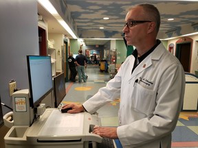 Edmonton ó Dr. Matt Wheatley of the neurosurgery department at the Stollery Childrenís Hospital looks up an electronic patient record. (Photo supplied by Alberta Health Services).