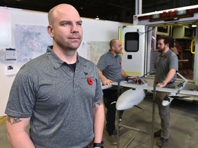 Veteran Cole Rosentreter, left, has transitioned into civilian life by founding Pegasus Imagery, along with veterans, in back,  John Hryniw and Joshua Richard, right, a company that uses drones to provide info to emergency services during disaster situations.