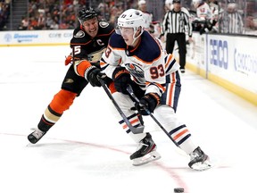 ANAHEIM, CALIFORNIA - NOVEMBER 10: Ryan Nugent-Hopkins #93 of the Edmonton Oilers controls the puck past Ryan Getzlaf #15 of the Anaheim Ducks during the second period of a game at Honda Center on November 10, 2019 in Anaheim, California.