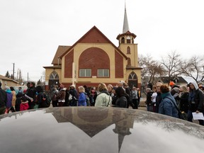 Marchers walk past the Mustard Seed during the 39th Annual Good Friday Outdoor Way of the Cross in Edmonton, on Friday, April 19, 2019.