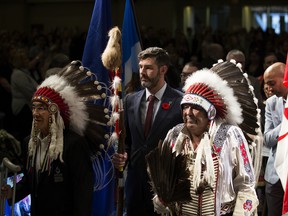 Grand Chief of the Confederacy of Treaty Six First Nations Wilton Littlechild, left, Mayor Don Iveson, and Alexis Nakota Sioux Nation elder Howard Mustus Sr. lead the grand entry during the opening ceremonies of the National Conference On Ending Homelessness at the Edmonton Convention Centre on Monday, Nov. 4, 2019.