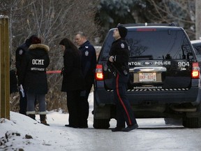 Police investigate a homicide in a residential alley near 92 Avenue and 77 Street in southeast Edmonton on Monday, Jan. 1, 2018.