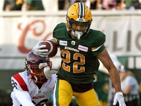 Edmonton Eskimos Jordan Robinson eludes a tackle from Montreal Alouettes Greg Reid during CFL game action in Edmonton on Friday June 14, 2019.