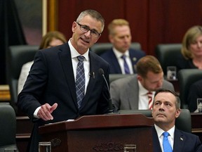 Alberta Finance Minister Travis Toews (left) delivers his budget speech as Alberta Premier Jason Kenney (right) listens at the Alberta Legislature in Edmonton on Thursday October 24, 2019.