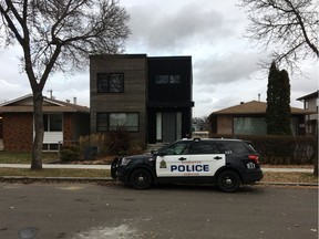 A police car is seen outside a residence near 88 Avenue and 91 Street on Sunday, Nov. 3, 2019, after two males were transported to hospital with life-threatening gunshot wounds.