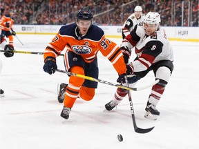 Edmonton Oilers' Connor McDavid (97) battles Arizona Coyotes' Jakob Chychrun (6) during the second period of a NHL hockey game at Rogers Place in Edmonton, on Monday, Nov. 4, 2019.