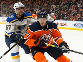 Edmonton Oilers' Oscar Klefbom (77) battles St. Louis Blues' David Perron (57) at Rogers Place in Edmonton on Wednesday, Nov. 6, 2019.