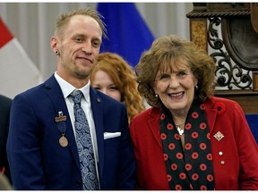 Edmontonian Ken Deardon, left, received the bronze medal for bravery from Lt.-Gov. Lois Mitchell at Government House in Edmonton on Friday, Nov. 8, 2019.