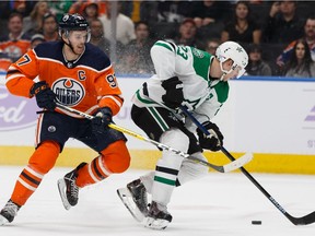 Edmonton Oilers' Connor McDavid (97) chases Dallas Stars' Esa Lindell (23) during the overtime period of a NHL hockey game at Rogers Place in Edmonton, on Saturday, Nov. 16, 2019.