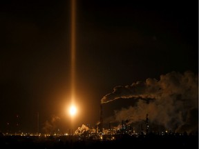 Light from a flare at Imperial Oil's Strathcona Refinery lights up the sky over Edmonton on Tuesday, Nov. 26, 2019.