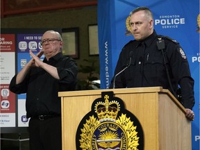 Edmonton Police Service Const. Trevor Claydon, right, and sign language interpreter Randy Dziwenka announce a partnership between the Edmonton Police Service and Deaf and Hear Alberta at police headquarters in Edmonton on Thursday, Nov. 28, 2019.