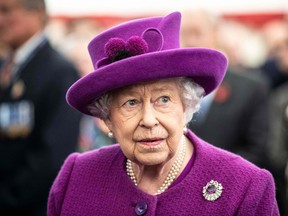 Queen Elizabeth II talks with volunteers and workers of the Royal British Legion Industries village in Aylesford, south of London, on Nov. 6, 2019, during a visit to celebrate the charity's centenary year.