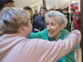 Dr. Eva Olsson, a Holocaust survivor who was liberated from the Bergen-Belsen work camp where Anne Frank died, embraces students from W.P. Wagner High School after her presentation on Tuesday, Nov. 5, 2019, at a new exhibit on Anne Frank at the Edmonton Public Schools archives. The exhibition explores the life of the 13-year-old girl during the Second World War.