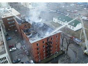 Firefighters hose down the Arlington apartment building at 100 Avenue and 106 Street in 2005 after a fire that started at approximately 3 a.m. forced the evacuation of all the residents in the heritage rental apartment building.