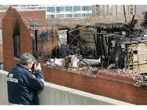 An Edmonton fire investigator takes pictures of what was left of the upper floors of the Arlington apartment building after a fire in April 2005. A former shareholder in the building is taking the majority shareholder to court in a case that's been billed as one of the oldest in the Edmonton court system.