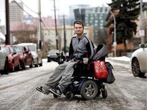 DATS user Levi Lawton poses for a photo outside his downtown apartment, in Edmonton Thursday Nov. 14, 2019. Levi is in a power wheelchair and uses the city's DATS service to get around. Levi says he regularly has to wait an hour to an hour and a half before the DATS bus arrives.