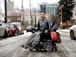DATS user Levi Lawton outside his downtown apartment in Edmonton on Thursday, Nov. 14, 2019. Levi is in a power wheelchair and uses the city's DATS service to get around. He says he regularly has to wait one hour to one-and-a-half hours before the DATS bus arrives.