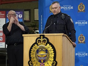 Edmonton Police Service (EPS) Constable Trevor Claydon (right) and sign language interpreter Randy Dziwenka (left) announced a partnership between the Edmonton Police Service and Deaf and Hear Alberta at police headquarters in Edmonton on Thursday November 28, 2019. A new tool to help police officers and drivers with hearing loss communicate more effectively with one another has been developed. The new communication card is one of the many ways that EPS is working together with the deaf, deafened, and hard of hearing community to address their needs, reduce barriers, and improve public safety. (PHOTO BY LARRY WONG/POSTMEDIA)