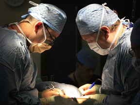 A surgeon and his team conduct a live donor kidney transplant at The Queen Elizabeth Hospital Birmingham on June 9, 2006, in Birmingham, England.