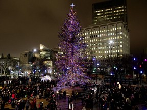 Edmontonians watch as the Christmas Tree is lit up during the Holiday Light Up event in Churchill Square, Thursday Nov. 14, 2019.