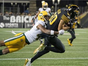 Hamilton Tiger-Cats wide receiver Jaelon Acklin (80) is tackled by Edmonton Eskimos defensive back Monshadrik Hunter (41) during first half CFL football game action in Hamilton, Ont., Friday, Oct. 4, 2019.