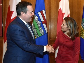 Alberta Premier Jason Kenney, left, greets Deputy Prime Minister and Intergovernmental Affairs Minister Chrystia Freeland at the Alberta legislature in Edmonton on Monday, Nov. 25, 2019.