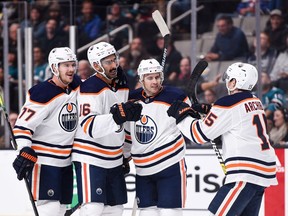 Edmonton Oilers left wing Jujhar Khaira (16) celebrates with teammates defenseman Oscar Klefbom (77) and defenseman Kris Russell (4) and right wing Josh Archibald (15) after scoring a goal against the San Jose Sharks during the first period at SAP Center in San Jose.