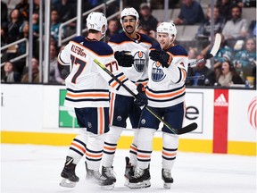 Edmonton Oilers left wing Jujhar Khaira (16) celebrates with defenseman Oscar Klefbom (77) and defenseman Kris Russell (4) after scoring a goal against the San Jose Sharks during the first period at SAP Center in San Jose.