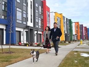 Jessamyn Gaspar and Jayson de Vera walk with Mr. Barclay, a Boston Terrier, outside their One at Keswick home in southwest Edmonton.