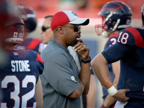 Montreal Alouettes head coach Khari Jones watches his team warm up prior to their game on July 4, 2019, against the visiting Hamilton Tiger-Cats.