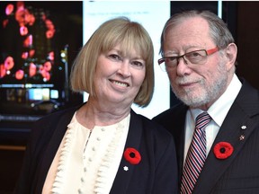 Edmonton philanthropists Dianne and Irving Kipnes standing in front of a poppy display to project onto the National Arts Centre in Ottawa, thanks to the Kipnes Lantern which is named after them, in Edmonton, Nov. 7, 2019.