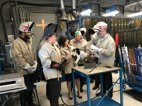 Education Minister Adriana Lagrange, third from left, takes part in a welding demonstration at St. Joseph's Catholic High School on Thursday, Nov. 7, 2019, where it was announced Skills Canada Alberta's annual funding will go from $1.5 million to $2 million.