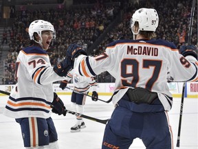 Edmonton Oilers defenceman Ethan Bear (74) and center Connor McDavid celebrate Bear's goal against the Vegas Golden Knights during the first period of an NHL hockey game Saturday, Nov. 23, 2019, in Las Vegas.