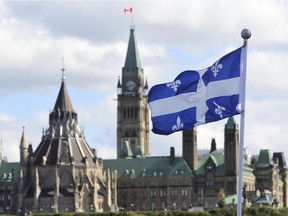 The Quebec flag is seen over looking the Ottawa River from the Civilization Museum behind Parliament Hill in Gatineau. File photo.
